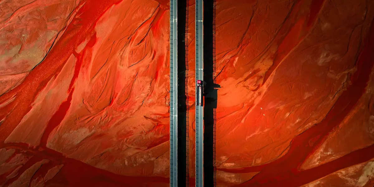 home hero image of bridge through a desert taken with a drone